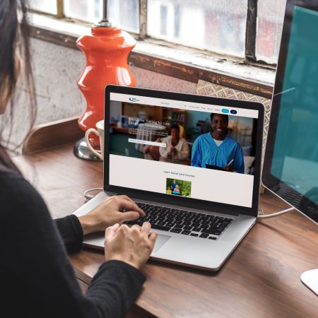 Laptop screen showing social care courses